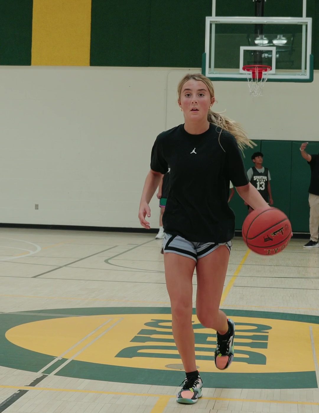 girl playing basketball and using sports training